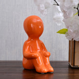 Nilkamal Boy Sitting with Folded Legs Polyresin Decorative Showpiece (Orange)